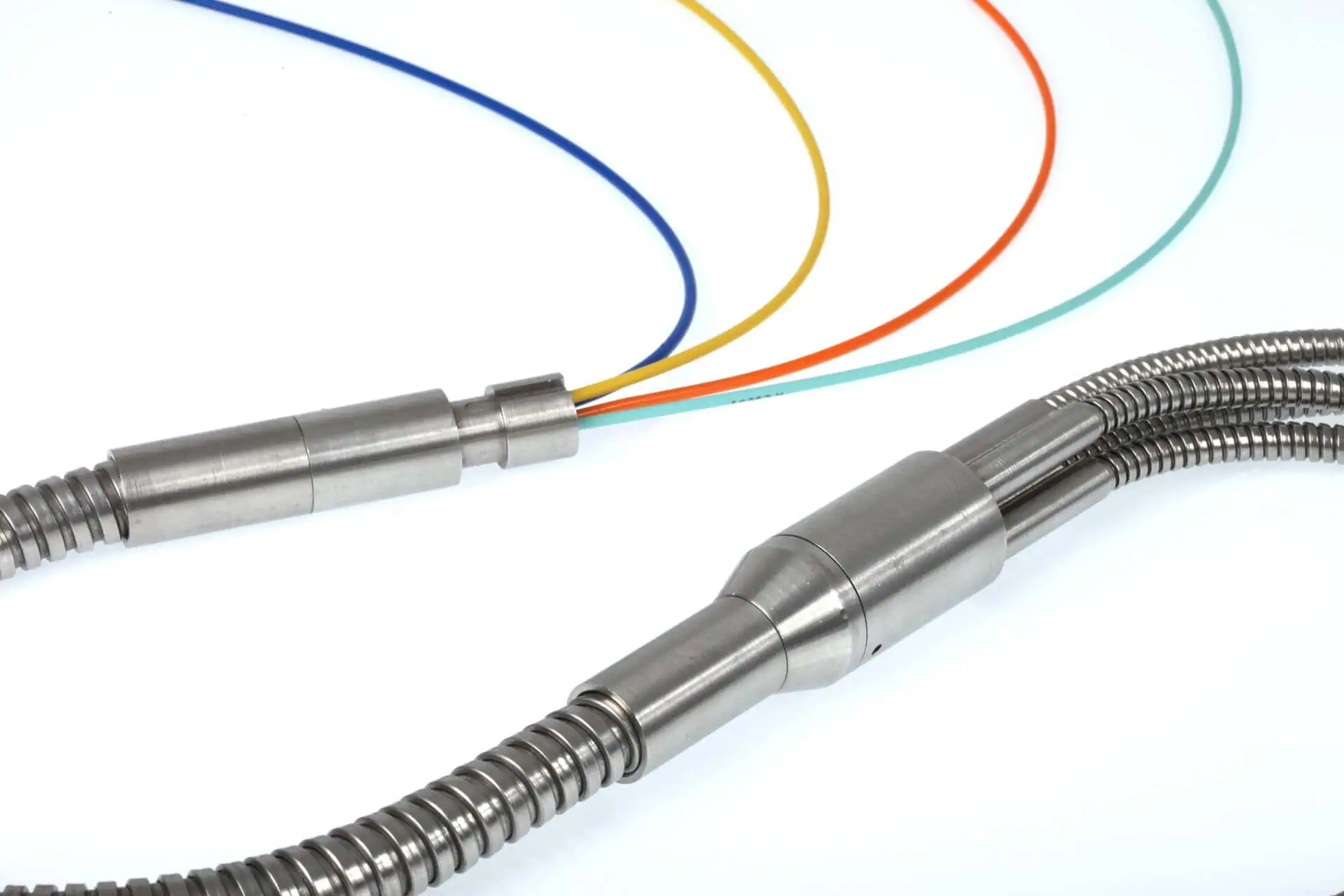 Two different cable assemblies on a white background. On the left, a single braided metal cable breaks out into four individual coloured cables. On the right, a Y-splitter for two ruggedized metal-braided cables is shown.